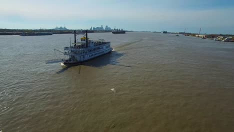 Very-good-aerial-over-a-paddlewheel-steamer-on-the-Mississippi-River-with-the-New-Orleans-skyline-in-distance