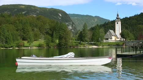 A-beautiful-shot-of-church-and-boat-at-Lake-Bohinj-Slovenia