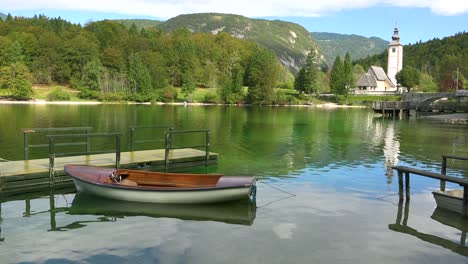 A-beautiful-shot-of-church-and-boat-at-Lake-Bohinj-Slovenia-1
