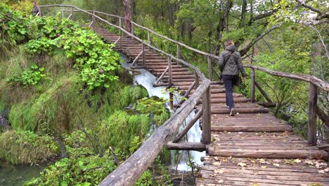 A-woman-walks-up-a-pathway-at-Plitvice-National-park