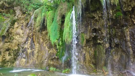 Beautiful-waterfalls-flow-through-lush-green-jungle-at-Plitvice-National-Park-in-Croatia-10