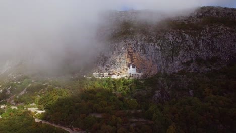 Beautiful-approaching-aerial-through-clouds-of-the-Ostrog-monastery-in-Montenegro