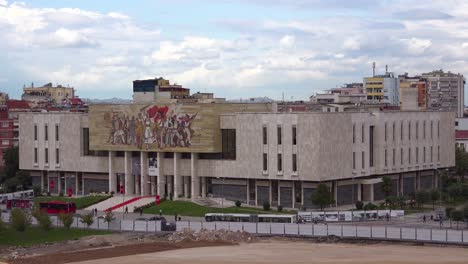 A-view-of-downtown-Tirana-Albania-streets-and-traffic-with-museum-and-revolutionary-Communist-mural-in-distance