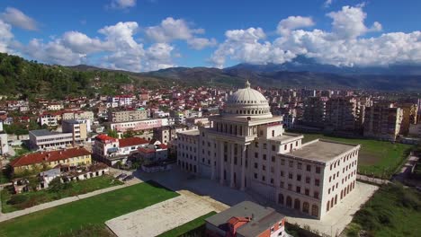 Beautiful-aerial-shot-over-large-capital-dome-or-government-building-at-Berat-Albania-1
