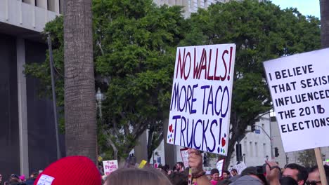 A-huge-protest-against-the-presidency-of-Donald-Trump-in-downtown-Los-Angeles-with-sign-saying-no-walls-more-taco-trucks