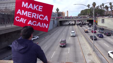 Protestors-against-Donald-Trump-stand-on-an-overpass-in-Los-Angeles-urging-people-to-make-America-gay-again