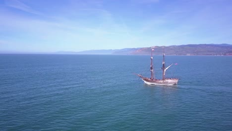 Spectacular-aerial-following-a-tall-sailing-ship-on-the-open-ocean-by-day-4