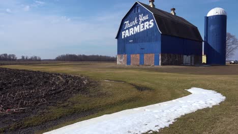 Low-angle-tilt-of-a-rural-barn-which-says-Thank-You-Farmers
