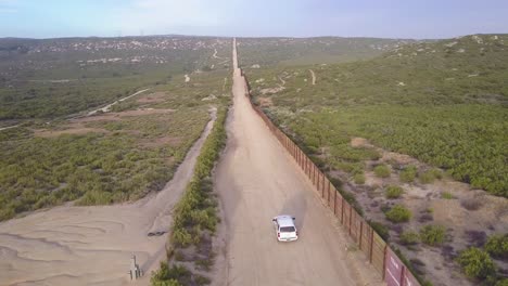 Vista-Aérea-over-a-border-patrol-vehicle-standing-guard-near-the-border-wall-at-the-US-Mexico-border-5
