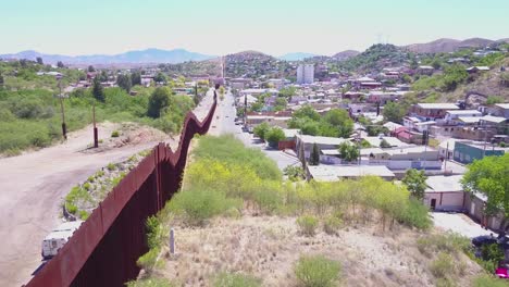 Aerial-over-a-border-patrol-vehicle-standing-guard-near-the-border-wall-at-the-US-Mexico-border-at-Nogales-Arizona