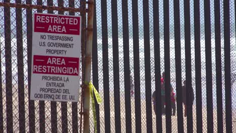 Signs-warn-of-a-restricted-area-at-the-US-Mexico-border-fence-in-the-Pacific-Ocean-between-San-Diego-and-Tijuana-1
