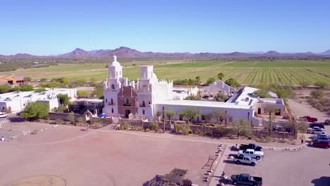 A-beautiful-vista-aérea-establishing-shot-of-Mission-San-Xavier-del-Bac-a-historic-Spanish-Catholic-mission-near-Tucson-Arizona-2