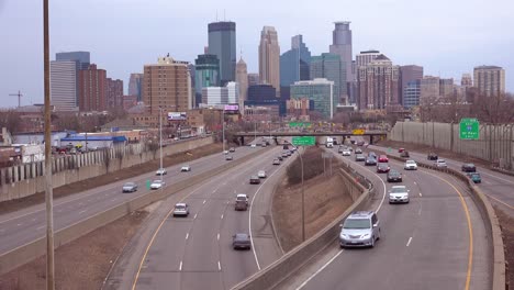 Freeway-traffic-moves-along-with-the-city-skyline-of-Minneapolis-Minnesota-background
