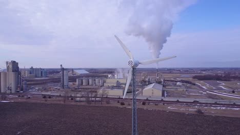 An-vista-aérea-shot-over-an-oil-refinery-with-a-windmill-foreground-contrasting-energy-sources