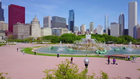 Beautiful-rising-aerial-shot-of-downtown-Chicago-with-fountain-foreground