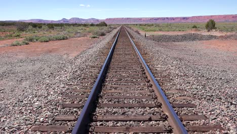 An-empty-railroad-track-stretches-to-the-horizon-in-the-Arizona-desert