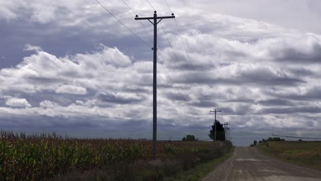 Beautiful-time-lapse-shot-of-dark-clouds-moving-over-a-lonely-road-in-the-Midwest