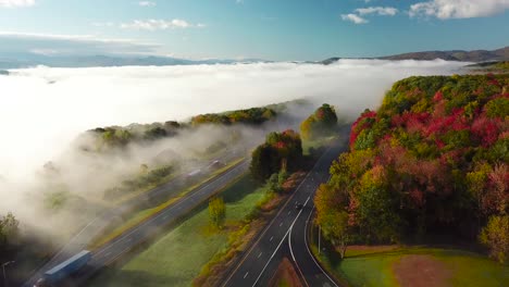 Beautiful-aerial-over-a-highway-through-the-fog-in-fall-in-New-England