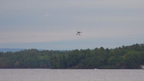 A-seaplane-lands-on-a-lake-in-Maine
