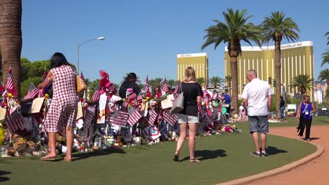 2017---thousands-of-candles-and-signs-form-a-makeshift-memorial-at-the-base-of-the-Welcome-to-Las-Vegas-sign-following-Americas-worst-mass-shooting-11