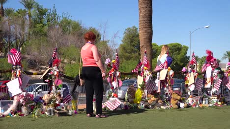 2017---thousands-of-candles-and-signs-form-a-makeshift-memorial-at-the-base-of-the-Welcome-to-Las-Vegas-sign-following-Americas-worst-mass-shooting-12