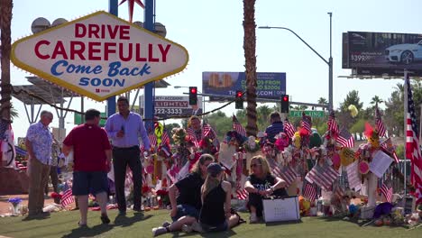 2017---thousands-of-candles-and-signs-form-a-makeshift-memorial-at-the-base-of-the-Welcome-to-Las-Vegas-sign-following-Americas-worst-mass-shooting-15