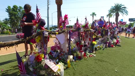 2017---thousands-of-candles-and-signs-form-a-makeshift-memorial-at-the-base-of-the-Welcome-to-Las-Vegas-sign-following-Americas-worst-mass-shooting-19