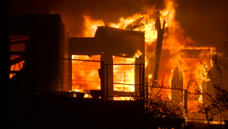 Close-up-of-a-home-burning-in-a-large-inferno-at-night-during-the-2017-Thomas-fire-in-Ventura-County-California