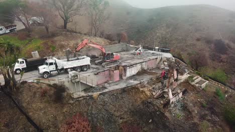 Aerial-of-a-house-being-bulldozed-on-a-hillside-in-Ventura-following-the-destruction-of-Thomas-Fire