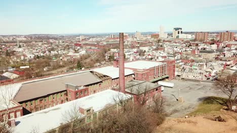 Aerial-over-an-abandoned-American-factory-with-smokestack-near-Reading-Pennsylvania-2