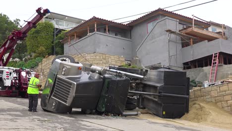 A-dump-truck-rolls-over-during-an-accident-on-a-construction-site-1