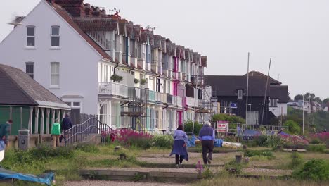 Pretty-and-colorful-rowhouses-or-cottages-line-a-beach-at-a-seaside-resort-in-England-1