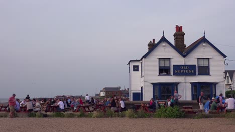 Good-establishing-shot-of-an-outdoor-picnic-area-at-a-pub-in-Whitstable-Bay-Kent-England-on-the-Thames-Estuary