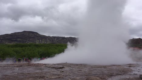Iceland's-famous-Strokkur-geysir-geyser-erupts-with-tourists-watching