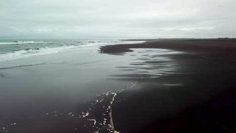 Haunting-beautiful-aerial-over-a-black-sand-beach-in-Southern-Iceland-4