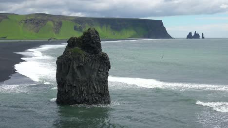 Beautiful-rock-formation-at-Dyrh_____‚laey-black-sand-beach-Iceland-1