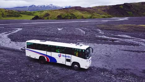 Aerial-over-a-bus-driving-through-a-river-in-the-highlands-of-Iceland-1