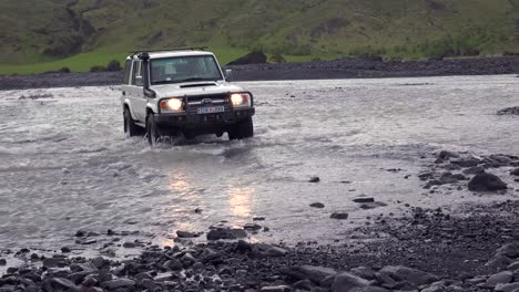 A-4WD-Toyota-Land-cruiser-drives-through-a-río-in-the-remopte-highlands-of-Iceland-near-Thorsmork