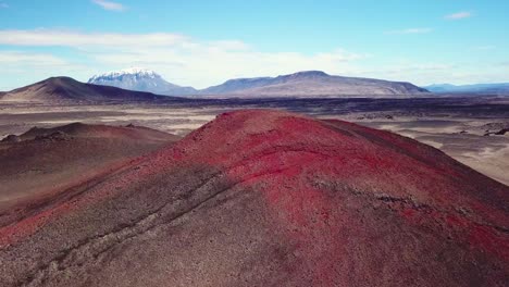 Spectacular-aerial-over-red-ash-topped-volcanoes-and-lava-flows-in-the-remote-highland-interior-of-Iceland-3