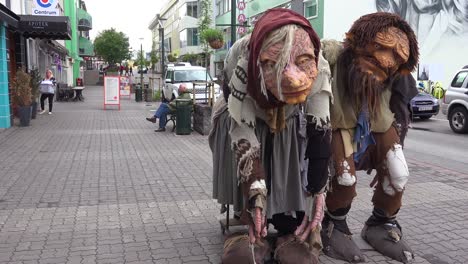 Two-giant-troll-figures-stand-on-the-streets-of-Akureyri-Iceland