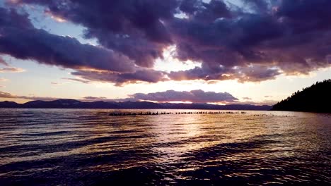 A-beautiful-aerial-over-Lake-Tahoe-Nevada-pier-pilings-in-water-at-sunset-or-sunrise
