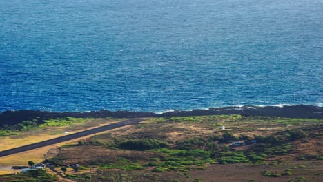 High-angle-establishing-shot-of-Kalaupapa-airport-and-small-plane-landing-on-the-island-of-Molokai-Hawaii-1