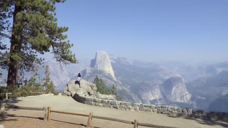 People-view-Half-Dome-and-the-High-Sierra-Mountain-Range-from-Washburn-Point-Yosemite-National-Park-California