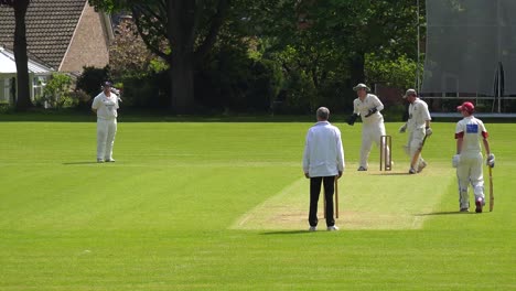 The-sport-of-cricket-is-played-on-a-green-grass-pitch-in-England