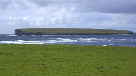 A-lighthouse-sits-on-a-remote-island-near-the-Orkney-Islands-of-Scotland