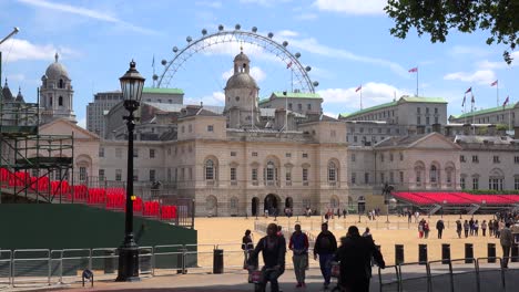 Pedestrians-walk-in-St-James-Park-in-London-with-London-Eye-background-1