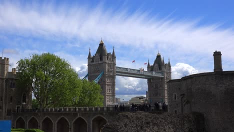 The-Tower-Bridge-in-London-England-is-seen-from-the-perspective-of-the-Tower-Of-London-with-beautiful-clouds-background