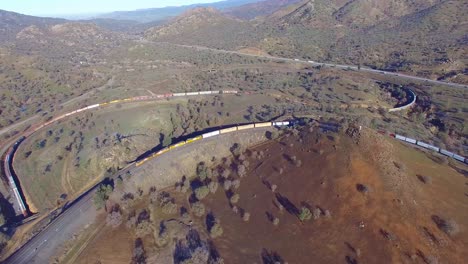 A-freight-train-travels-the-remarkable-Tehachapi-Loop-in-California's-desert-making-a-full-circle-around-itself