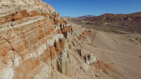 An-aerial-along-a-beautiful-dry-cliff-face-in-the-remote-Mojave-Desert-of-California-or-Nevada