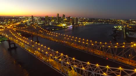 Beautiful-night-aerial-shot-of-the-Crescent-City-Bridge-over-the-Mississippi-River-revealing-the-New-Orleans-Louisiana-skyline